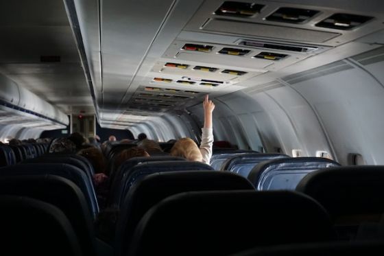 unaccompanied young child travelere pushing airplane call button