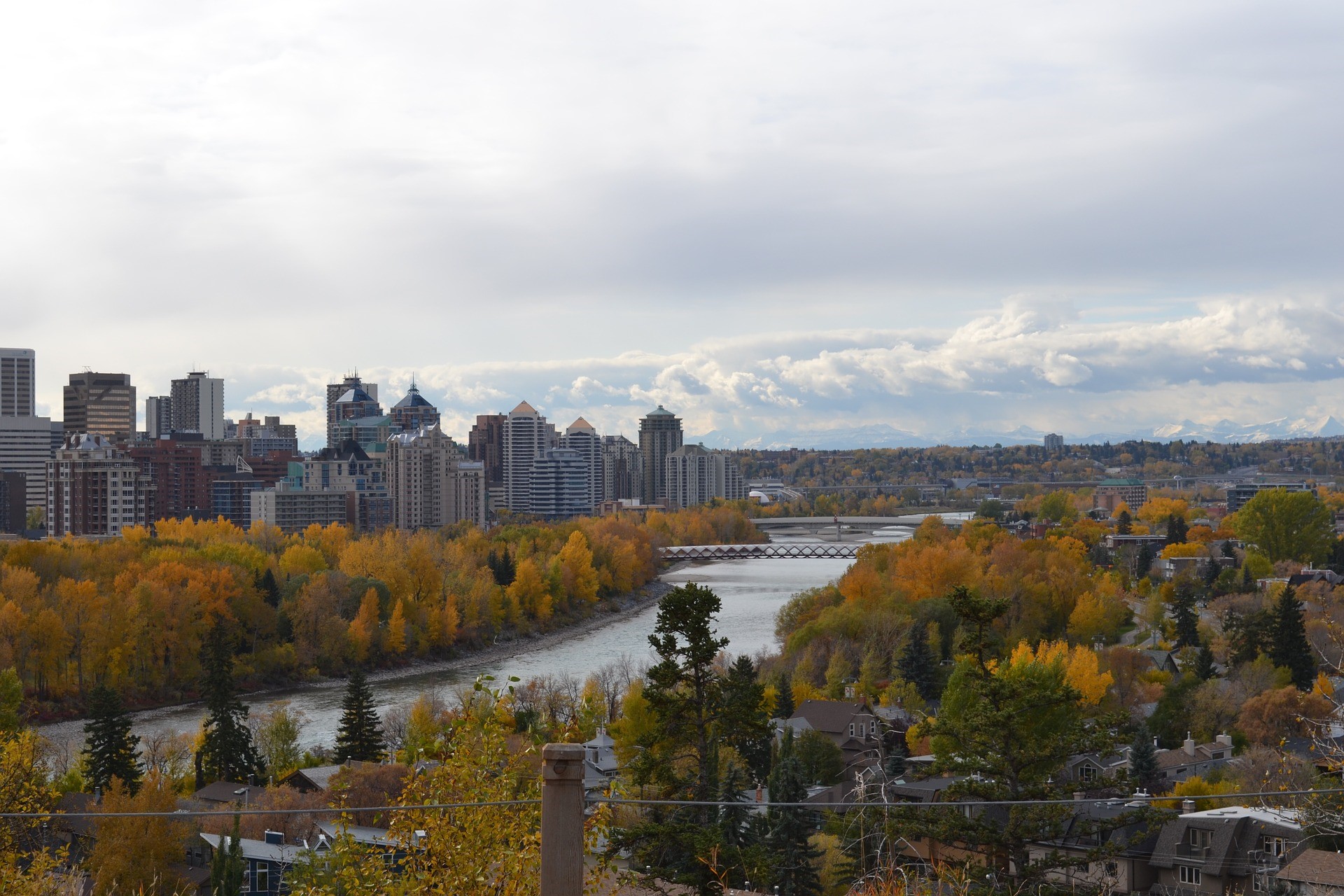 a view of the Calgary, Alberta skyline and Bow River with fall foliage