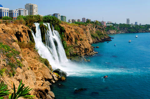 Photo of the Antalya Turkey waterfall showing city on cliff and ocean below