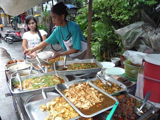 Street food vender serving a customer in Bangkok