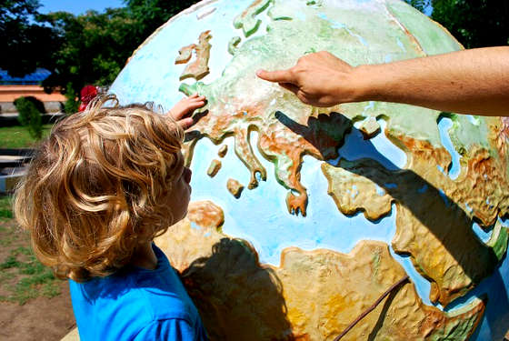 Minor choosing travel destination on world map