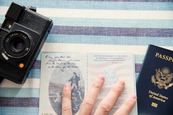open passport book next to a camera
