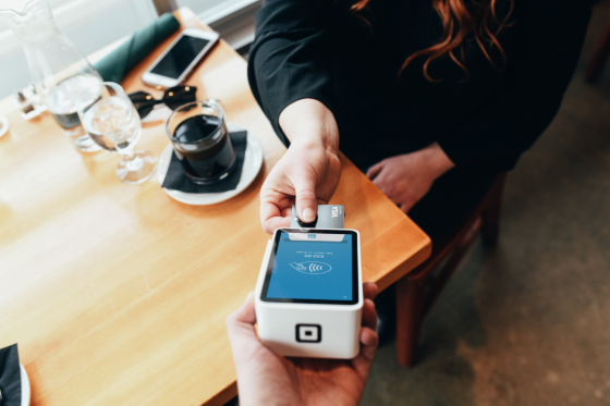 a woman paying with a credit card