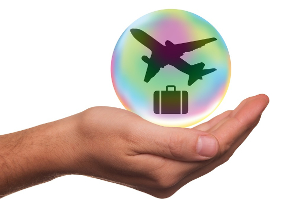 hand holding luggage and plane images in a bubble