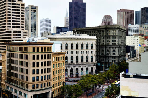 San Francisco buildings with American flag flying on right side.