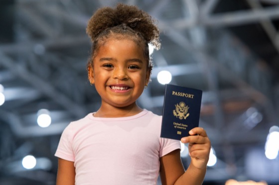 A child holding a passport for a minor