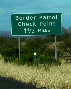 Green US border inspection station road sign