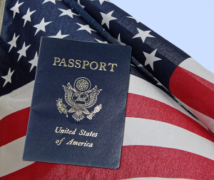 blue US passport in front of American flag