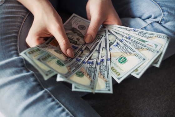 a handful of 100 dollar bills