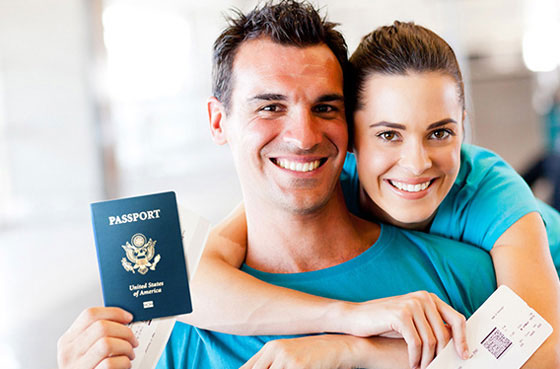 Happy couple holding passports