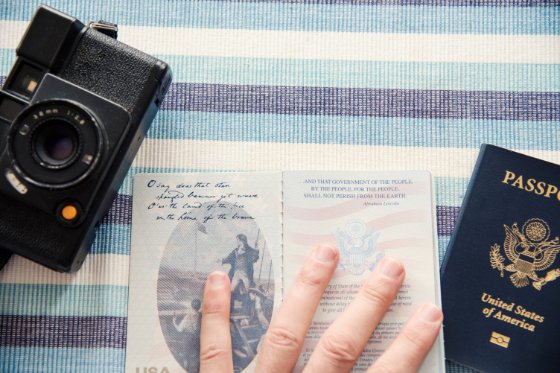 open passport book next to a camera