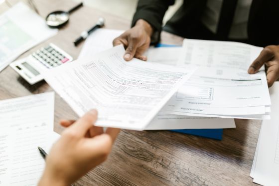 travel insurance papers being handed across a desk