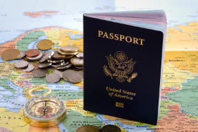 U.S. Passport on Map beside compass and several coins
