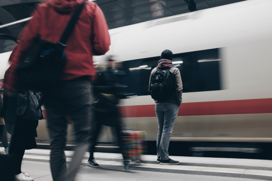 man waiting on a train platform