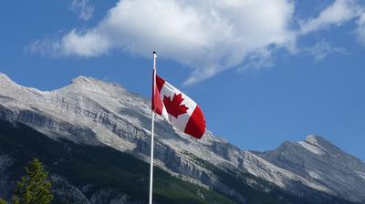 Canadian Flag with Mountains in Background