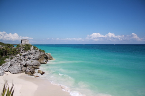 The Mayan Ruins of Tulum seen at a distance from the beach. Tulum Mayan Ruins